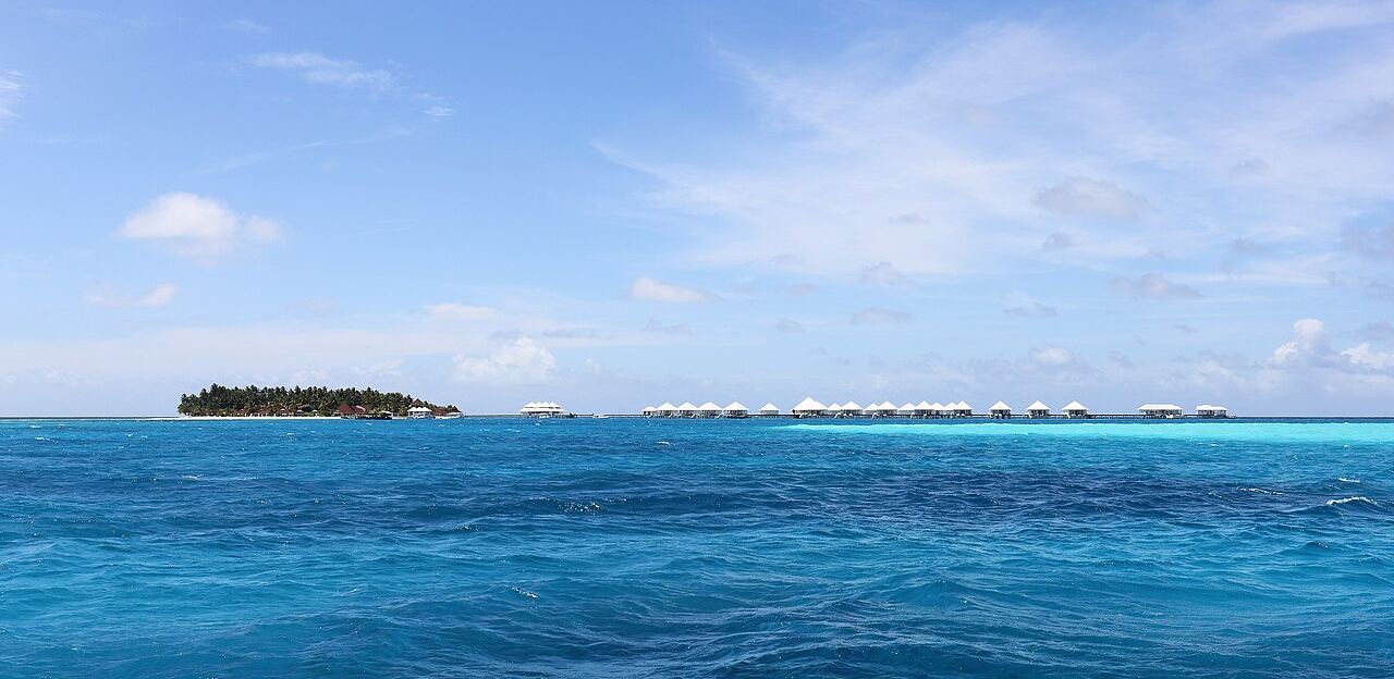 Beach and overwater villas on a turquoise lagoon in the Maldives