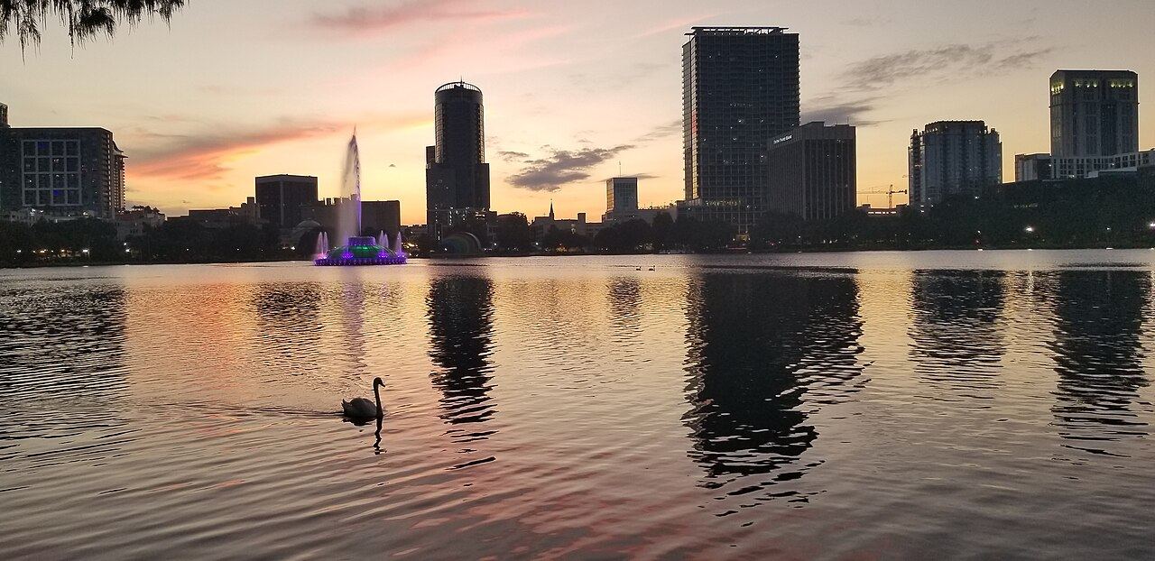Lake Eola in downtown Orlando at sunset with a swan boat