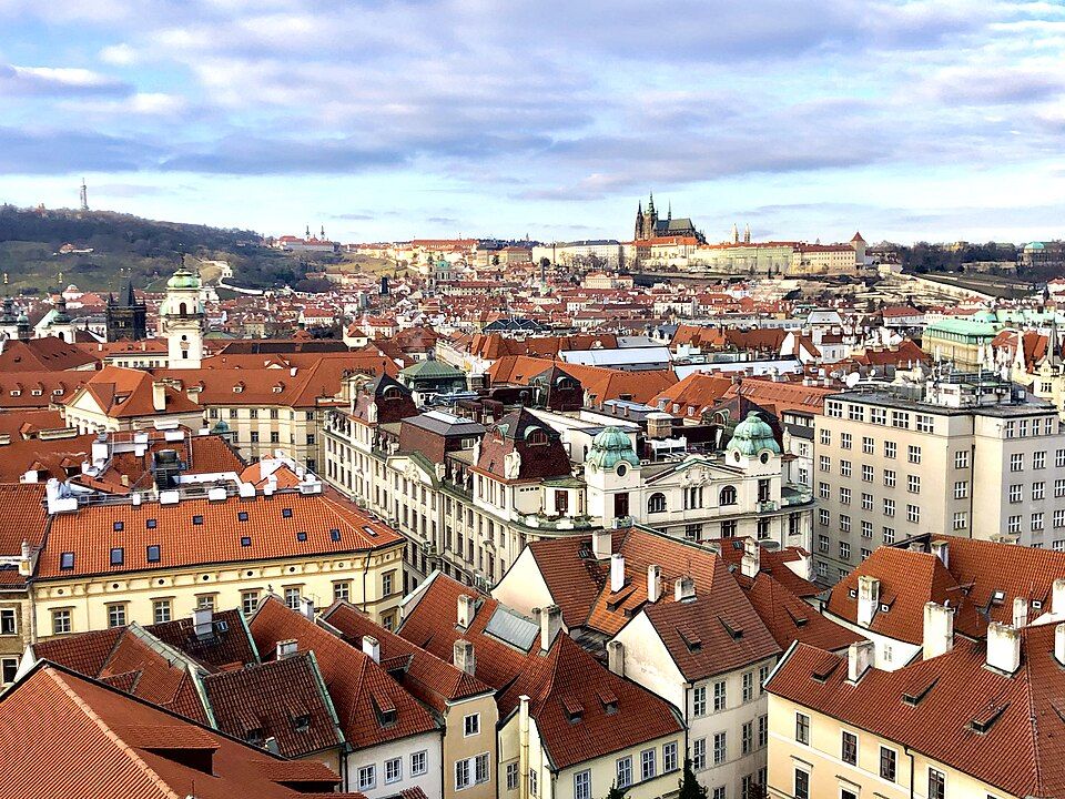 Red rooftops and towers of Prague's Old Town on a sunny day